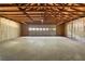 Spacious garage interior with concrete flooring and open ceiling at 2871 Tucker Mill Sw Rd, Conyers, GA 30094
