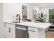 Kitchen sink and peninsula offer a breakfast bar and an inviting space to enjoy the open living space at 2871 Tucker Mill Sw Rd, Conyers, GA 30094