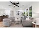 Bright living room with updated ceiling fan and natural light from surrounding windows offering a relaxing space at 2871 Tucker Mill Sw Rd, Conyers, GA 30094