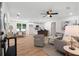 Open-concept living room seamlessly connects to the kitchen and dining area, featuring hardwood floors and neutral decor at 2871 Tucker Mill Sw Rd, Conyers, GA 30094