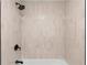 Elegant shower with vertical white tile, matte black fixtures, and a tub at 2871 Tucker Mill Sw Rd, Conyers, GA 30094
