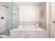 Modern bathroom featuring a marble-tiled shower and soaking tub at 3235 Roswell Ne Rd # 505, Atlanta, GA 30305