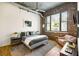 Comfortable bedroom featuring exposed brick, ductwork, and hardwood floors at 3235 Roswell Ne Rd # 505, Atlanta, GA 30305