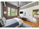 Comfortable bedroom with exposed brick wall, ductwork, hardwood floors and natural light at 3235 Roswell Ne Rd # 505, Atlanta, GA 30305