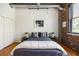 Cozy bedroom with exposed brick wall, hardwood floors, and abundant light at 3235 Roswell Ne Rd # 505, Atlanta, GA 30305