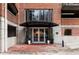 Brick apartment building entrance with covered awning and potted plants at 3235 Roswell Ne Rd # 505, Atlanta, GA 30305