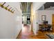 Hallway leading to living area with exposed ductwork and hardwood floors at 3235 Roswell Ne Rd # 505, Atlanta, GA 30305