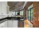 Modern kitchen with stainless steel dishwasher, granite counter, and open view to the living area at 3235 Roswell Ne Rd # 505, Atlanta, GA 30305