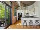 Modern kitchen with barstool seating and balcony access, offering indoor/outdoor living at 3235 Roswell Ne Rd # 505, Atlanta, GA 30305