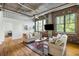 Spacious living room with modern decor, exposed pipes, and large windows for ample lighting at 3235 Roswell Ne Rd # 505, Atlanta, GA 30305