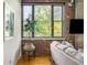 Comfortable living room space with large windows, a stylish plant, and exposed brick walls at 3235 Roswell Ne Rd # 505, Atlanta, GA 30305
