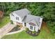 Aerial view of home featuring a landscaped front yard, driveway, and mature trees at 2426 Corner Shoals Dr, Decatur, GA 30034