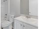 Bright bathroom featuring a white vanity, toilet, and shower-tub combo with chrome fixtures at 2426 Corner Shoals Dr, Decatur, GA 30034
