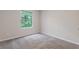 Well-lit bedroom with a large window and plush carpet flooring. Freshly painted in neutral color at 2426 Corner Shoals Dr, Decatur, GA 30034