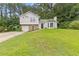 View of home highlighting its well-maintained lawn, garage, and classic architecture at 2426 Corner Shoals Dr, Decatur, GA 30034