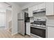 Well-lit kitchen boasts stainless steel appliances and white cabinets, complemented by sleek countertops at 2426 Corner Shoals Dr, Decatur, GA 30034