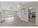 Open concept living room featuring luxury vinyl plank flooring, modern lighting and white kitchen at 2426 Corner Shoals Dr, Decatur, GA 30034