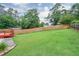 Spacious backyard enclosed by a wooden fence, offering a serene outdoor space with a glimpse of a deck and lush greenery at 281 Lakeshore Ne Dr, Marietta, GA 30067