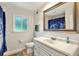 Bright bathroom with a white vanity, large mirror, and a toilet at 281 Lakeshore Ne Dr, Marietta, GA 30067