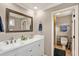Bathroom with white double sink vanity, large framed mirror, and walk-in shower at 281 Lakeshore Ne Dr, Marietta, GA 30067