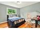 Bedroom with wood floors, and a large window with backyard views at 281 Lakeshore Ne Dr, Marietta, GA 30067