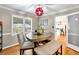 Inviting dining room with an unique table, complemented by bright windows and an adjacent kitchen, creating a seamless flow at 281 Lakeshore Ne Dr, Marietta, GA 30067