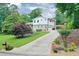 Charming home featuring manicured lawn, brick accents, attached garage and lengthy driveway at 281 Lakeshore Ne Dr, Marietta, GA 30067