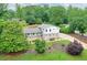 A charming two-story home nestled among lush trees, showcasing its inviting front yard and well-manicured landscaping at 281 Lakeshore Ne Dr, Marietta, GA 30067
