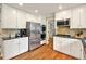 Well-equipped kitchen with stainless steel appliances, white cabinets, and granite countertops, ideal for cooking enthusiasts at 281 Lakeshore Ne Dr, Marietta, GA 30067