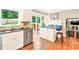 Open-concept kitchen with stainless steel appliances, a breakfast bar, and seamless access to the outdoor deck, perfect for modern living at 281 Lakeshore Ne Dr, Marietta, GA 30067