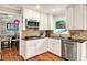 Modern kitchen featuring stainless steel appliances, white cabinetry, and a stylish backsplash, designed for functionality and style at 281 Lakeshore Ne Dr, Marietta, GA 30067
