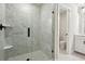 Modern bathroom featuring a frameless glass shower with marble-look tile and black hardware at 5120 Kongoni Ct, Cumming, GA 30041