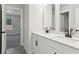 Clean and functional bathroom featuring a double vanity, and adjacent bedroom at 5120 Kongoni Ct, Cumming, GA 30041