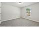 Bright bedroom with plush carpet, window, and fresh paint at 5120 Kongoni Ct, Cumming, GA 30041