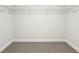 Walk-in closet with carpet flooring and adjustable wire shelving system at 5120 Kongoni Ct, Cumming, GA 30041