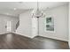 Bright dining area featuring modern chandelier, hardwood floors, and staircase access at 5120 Kongoni Ct, Cumming, GA 30041
