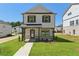 Beautiful two-story home with a covered porch and lush green lawn at 5120 Kongoni Ct, Cumming, GA 30041