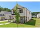 Charming two-story home with white siding, black trim, and well-manicured lawn at 5120 Kongoni Ct, Cumming, GA 30041