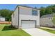 Charming two-story home with a white facade, a paved driveway, and an attached garage at 5120 Kongoni Ct, Cumming, GA 30041