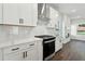 Well-lit kitchen featuring stainless steel appliances, a gas range, and white cabinetry at 5120 Kongoni Ct, Cumming, GA 30041