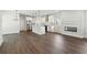 Spacious open-concept living area with modern kitchen, fireplace, and hardwood floors at 5120 Kongoni Ct, Cumming, GA 30041