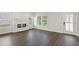 Bright living room with a modern fireplace, large windows, and hardwood floors at 5120 Kongoni Ct, Cumming, GA 30041