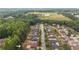 Aerial neighborhood view with wooded areas featuring a community pool at 8744 Hamil Ct, Douglasville, GA 30135
