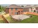 Brick home featuring a backyard with a patio, retaining wall, and a wood fence at 8744 Hamil Ct, Douglasville, GA 30135