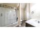 Bright bathroom with modern vanity, sleek fixtures, and a tub with glass sliding doors at 8744 Hamil Ct, Douglasville, GA 30135