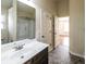 A bathroom features a vanity with marble countertops, modern fixtures, and a tub with a shower at 8744 Hamil Ct, Douglasville, GA 30135