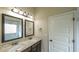 Bathroom features double sinks with granite countertop and large mirrors at 8744 Hamil Ct, Douglasville, GA 30135