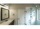 Bathroom features a shower with glass door, a framed mirror, and marble countertops at 8744 Hamil Ct, Douglasville, GA 30135