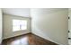 Bright bedroom featuring a large window, hardwood floors, and neutral walls for a cozy feel at 8744 Hamil Ct, Douglasville, GA 30135