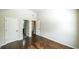 Inviting bedroom with high ceilings, hardwood floors, and multiple doors for easy access at 8744 Hamil Ct, Douglasville, GA 30135